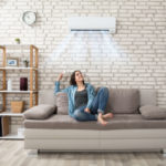 Person staying cool in the home with their AC. Apex Air, serving Portland OR & Vancouver explains how to stay in the summer.