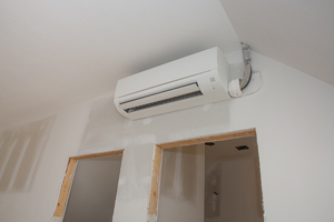 Mini-split ductless air conditioning unit installed in unfinished room - Apex Air in Vancouver WA talks about how much mini split installation costs and the factors that go into the cost.